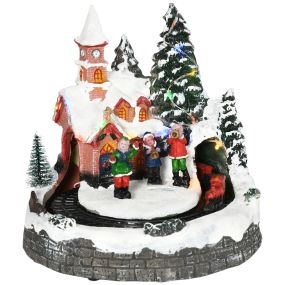 Pueblo navideño iluminado con luces LED, árbol, música y tren móvil, 20x19,5x20 cm multicolor